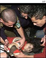An injured woman is being treated by paramedics