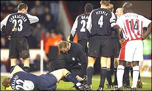 Liverpool keeper Chirs Kirkland lies on the ground receiving treatment after a tackle by Michael Brown