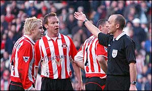 Sunderland players are furious as referee Mike Dean orders that Tommy  Smith's second half spot-kick must  be taken again after goalkeeper Thomas Sorensen saved his first effort