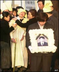 The wife, second from left, and other relatives of one of the victims