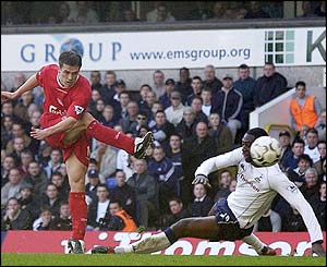 Michael Owen's shoots as Ledley King tries to block but the England  striker levels the scores