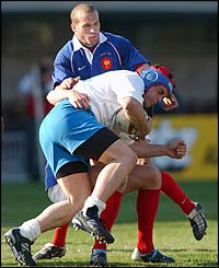 Italy's Andrea Masi is tackled by Frederic Michalak