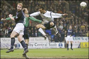 Spurs defender Gary Doherty and keeper Kasey Keller clear the ball from Bolton's Youri Djorkaeff