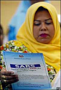 A Malaysian women reads about SARS