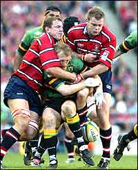 Gloucester's Adam Eustace (left) and Andy Hazell (centre) tackle Northampton's Matt Dawson 
