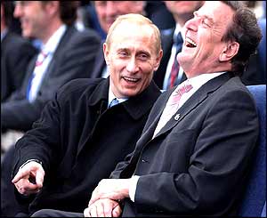 Russian President Vladimir Putin shares a joke with German Chancellor Gerhard Schroeder