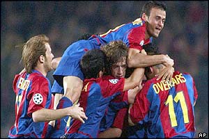 Barcelona's Luis Enrique, top, jumps on top of various team-mates after  Xavi scores against Juventus