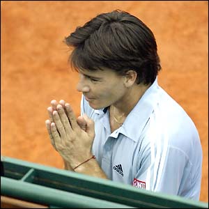 Guillermo Coria begs a ball girl (out of picture) to forgive him after throwing his racket in a tantrum  