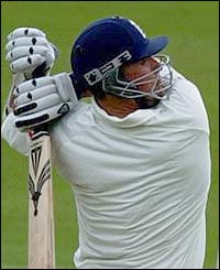 Darren Gough hits a boundary on his way to his 34 runs  