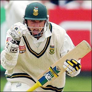 Graeme Smith celebrates as he becomes the second batsman ever to score double-centuries in successive Tests versus England 