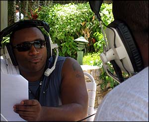Rampage (background) talks to DJ Slic (foreground) poolside broadcast from Trinidad Carnival 