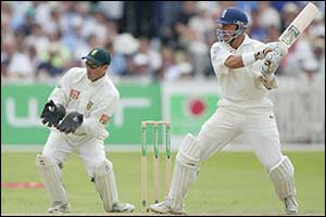 Alec Stewart hits a boundary as he  past 50 and guides England past 400 runs 