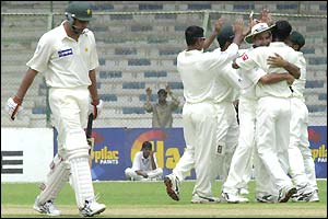 Pakistan batsman Inzaman-ul-Haq  leaves the field as the Bangladeshi players celebrate his wicket