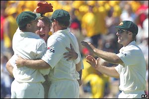 Andy Bichel (second right) is congratulated by his Australian team-mates after dismissing Akash Chopra