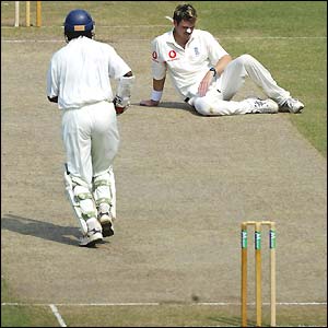 James Anderson (right) sits on the ground and looks frustrated as England fail to take any further Sri Lankan wickets