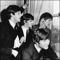 The band wave at fans from their Plaza hotel window off Central Park.