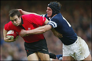Wales' Rhys Williams tries to get past Scotland's Tom Philip