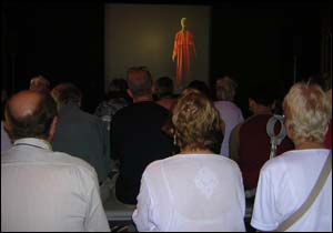 Some of the many people who attended the event watching films on Saudi heritage in a  Bedouin tent