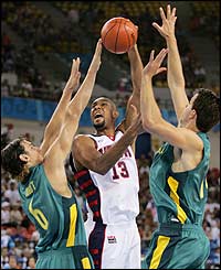 Australia try to defend against USA's Tim Duncan (centre)