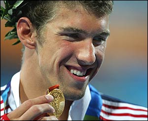 Phelps celebrates on the podium during the medal ceremony