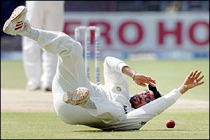 Sachin Tendulkar attempts to stop a shot by Taufeeq Umar 