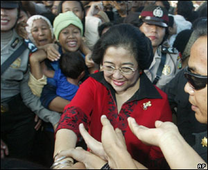 Megawati Sukarnoputri  meets voters outside a polling station in Jakarta