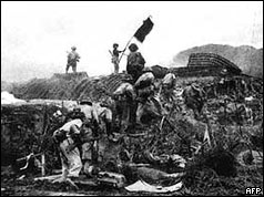 Viet Minh soldier waves flag after victory at Dien Bien Phu