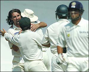 Gillespie is congratulated  by his team-mates after removing Sachin Tendulkar