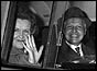 Helen and Peter smiling and waving in back of van