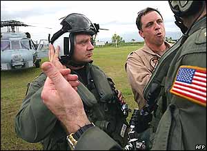 US Navy personnel from the USS Abraham Lincoln talk after touching down at the airport in Banda Aceh, 01 January 2005