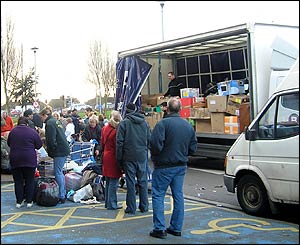 Residents of Cardiff, Wales collect aid and load it onto vehicles for disaster victims