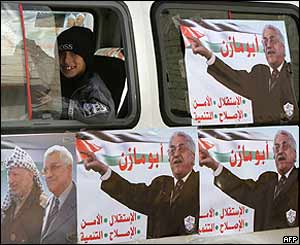 Palestinians boy looks from a vehicle covered with campaign posters of presidential candidate Mahmoud Abbas,  Abu Dis, West Bank
