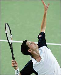 Henman serves steadily and looks comfortable as he races into an early lead