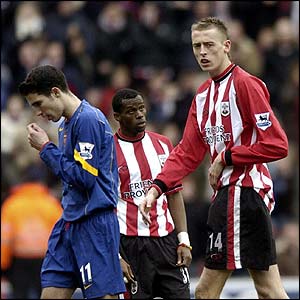 Southampton players look on as  Robin van Persie leaves the pitch