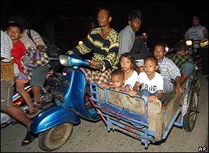 Family sets off on scooter for higher ground