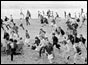 Crowd running on beach at Brighton  