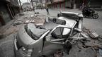 四川雅安宝兴县灵关镇街头一辆汽车被地震震落的瓦砾砸毁（22/4/2013）