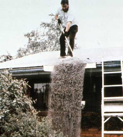 A man sweeps ash from his roof photo: USGS