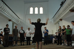 'Marie Benton conducting The Choir With No Name'