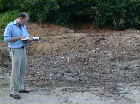 John Hamnel near a mass grave.