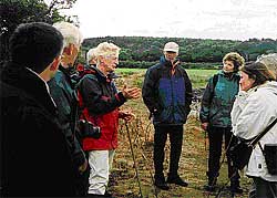Tom McErlean (centre)  explains stone fish trap design