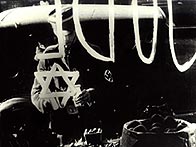 Member of Hitler Youth paints a 'Star of David'  on a Jewish-owned shop