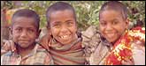 Saket Street Kids CU: Street beggars playing and laughing, Saket, Delhi.