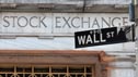 New York Stock Exchange with Wall Street roadsign in foreground