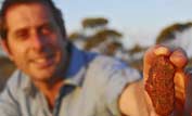 Dr Iain Stewart with meteorite found on Nullarbor Plain, south western Australia