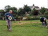 Image of local historians surveying a field
