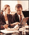 2 people around a laptop