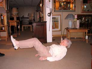 Mrs Jean L'Amie, a Linton and Robinson customer, shows she can still touch her toes at the young age of 99
