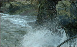 Waves crah against the Polperro cliffs