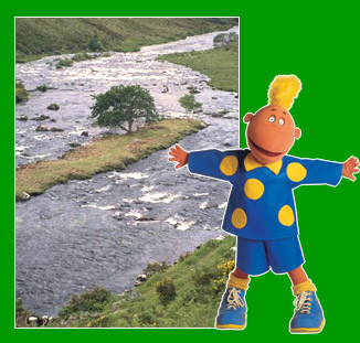 Jake in front of stream joining river